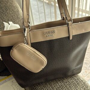 Guess tote. 14 1/2 wide plenty of sections 10 inches in length. Zipper in middle